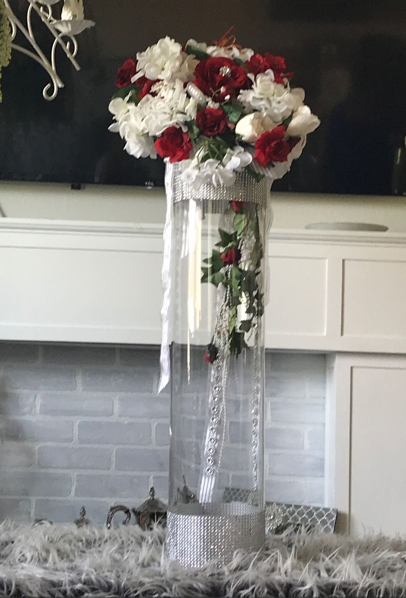 Red and white flower with tall vase