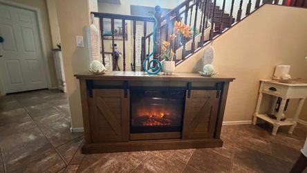Farmhouse fireplace /tv stand with sliding barn doors in excellent condition