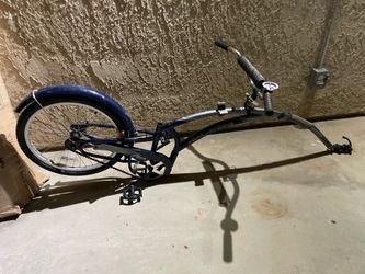 Bike that attaches to the seat post of another bike to make it tandem.