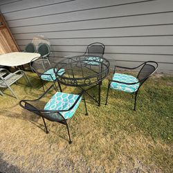 Metal And Glass Top Patio Set With Four Matching Chairs