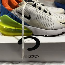Nike Air Max 270 sneakers in white with bold orange, blue, and neon accents