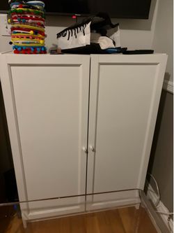 2x white storage cabinets