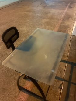 Glass desk and a rolling chair