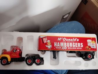 The item shown in the image is a 1:50 scale Matchbox Dinky 1955 Mack B-61 tractor-trailer featuring a classic McDonald's "Hamburgers
