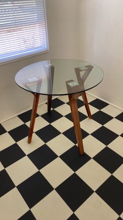 Glass top table with wooden legs