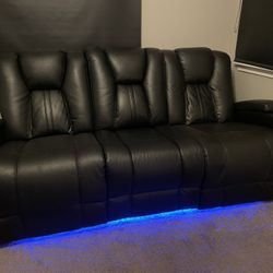 Black Leather Sofa. Dual power reclining, USB ports, theater lighting, cup holders, fold down table