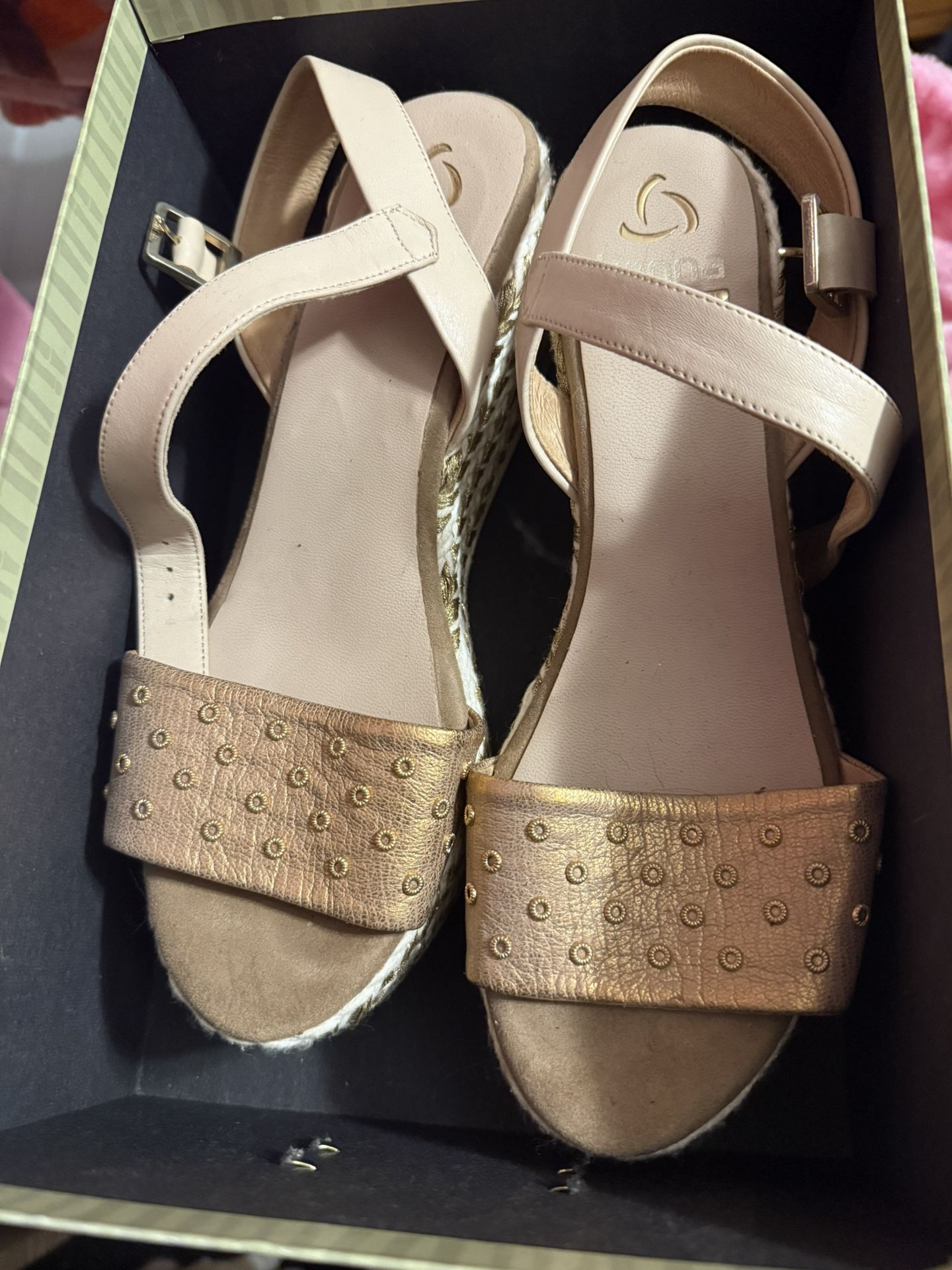 Pair of rose gold espadrille wedge sandals