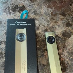 The Olight flashlight includes both a laser and a blue light, adding extra functionality. 