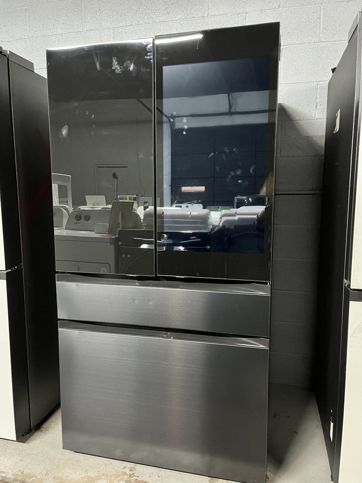 Samsung refrigerator 29  cu. ft with large family hub in Black glass and stainless steel Panels.
