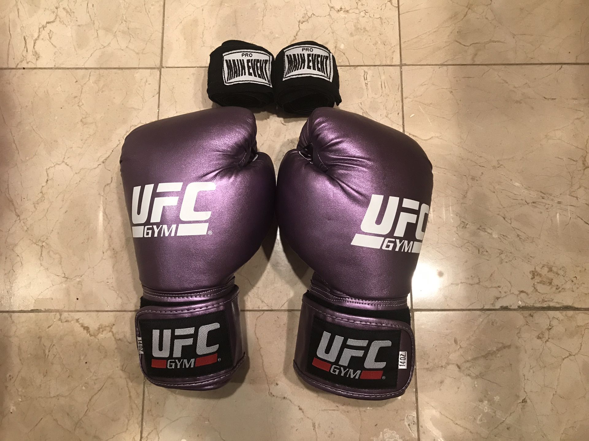 One pair of purple official UFC gloves with 2 wrist wraps
