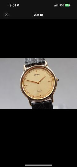 Seiko Dolce wristwatch with a minimalist gold-tone dial and a black leather strap.