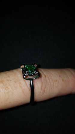 A size 9 rhodium plated Emerald stone ring