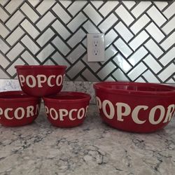 3 small and 1 large ceramic popcorn bowls.
