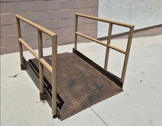 heavy-duty steel wheelchair ramp, approximately 3 feet wide and 4 feet long.