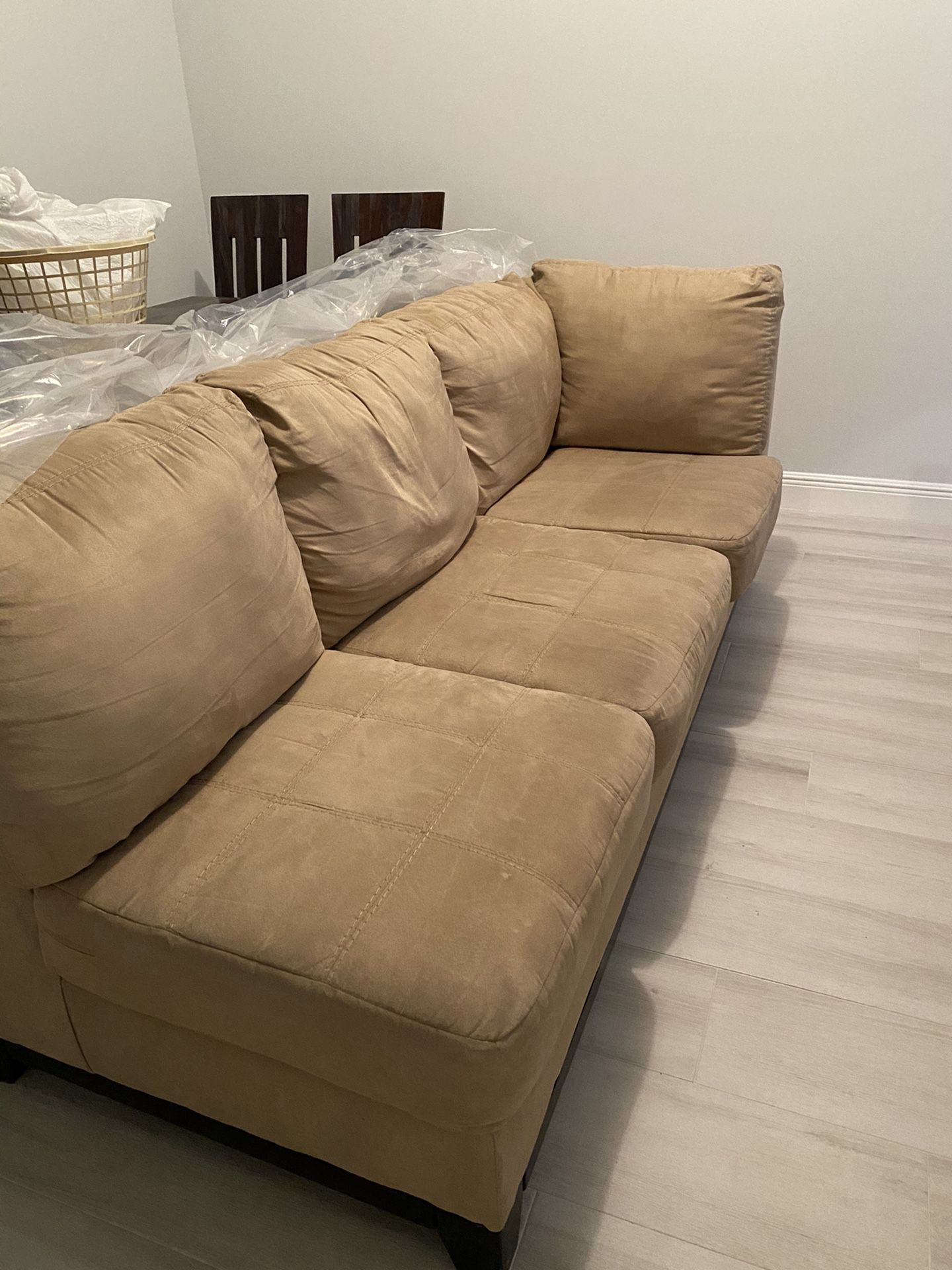 Sectional couch included with a square ottoman same color.