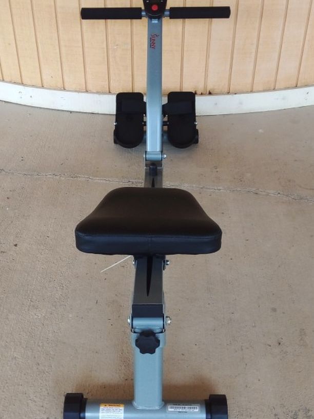 Seated back rowing exercise machine. Multiple levels of resistance, comes with built in clock, timer and counter.