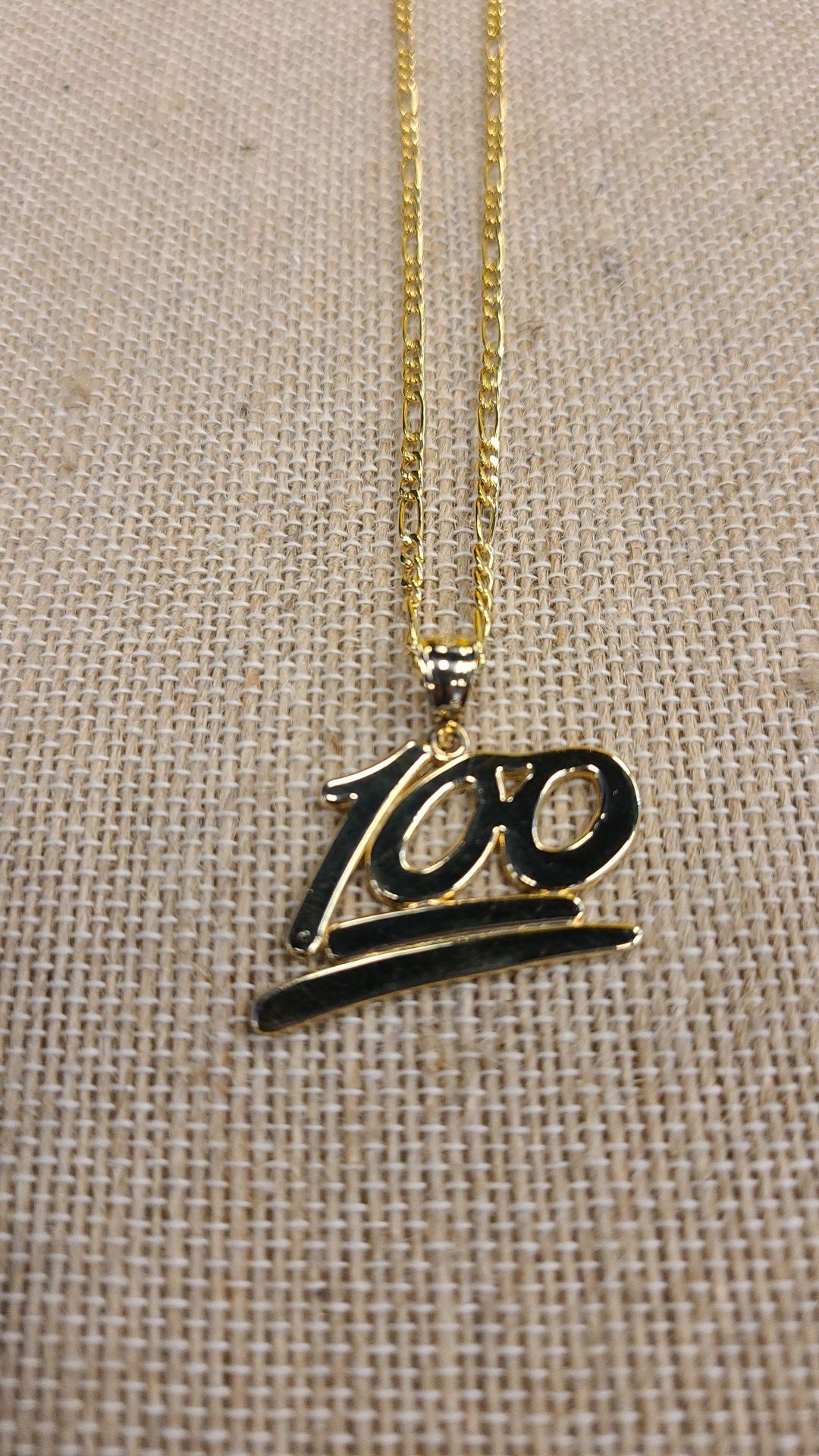 10k gold Figaro chain with 100 charm