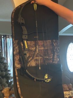 Barnett youth compound bow with a camouflage soft carrying case.