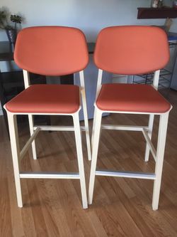 Two bar stools solid birch wood, orange leather seats
