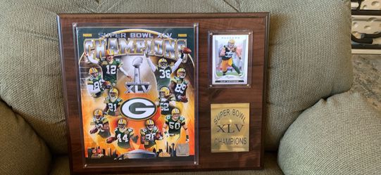 Commemorative plaque celebrates the Green Bay Packers' Super Bowl XLV championship. The display features a large "Champions" graphic with key player C
