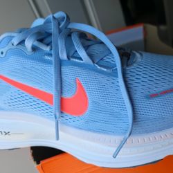 Nike Vomero 18 in a light blue and bright crimson colorway