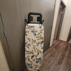 Completely new, unused ironing board.