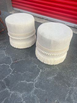 Penelope Fringe Drum Ottoman ivory round drum ottomans featuring decorative tassel/fringed skirts and trim details
