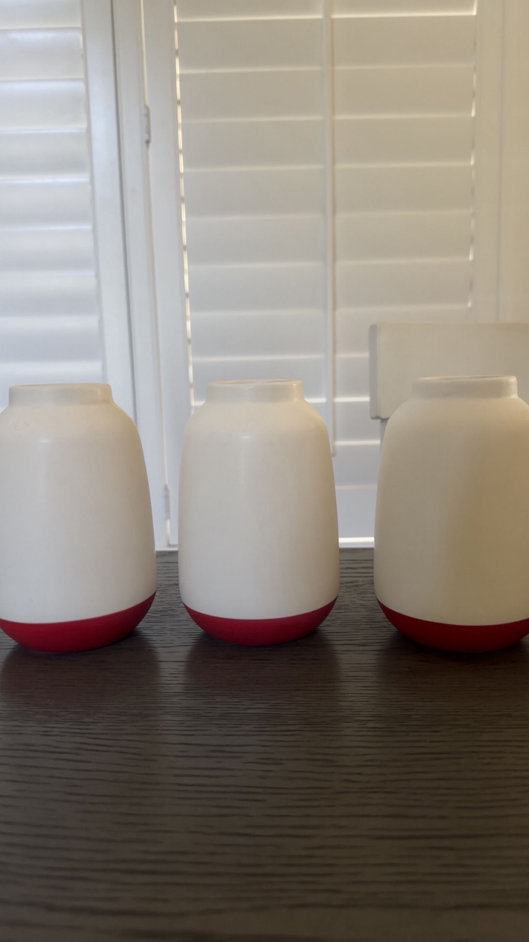 white vases with a red bottom