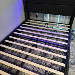 LED full sized bed frame with 4 storage drawers underneath 