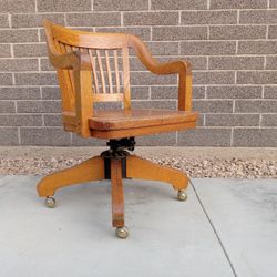 Vintage bankers roll /swivel arm oak chair