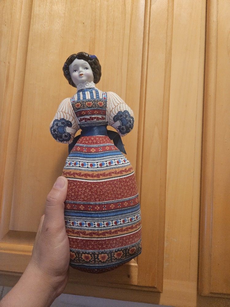 Vintage Avon porcelain doll. Features a fabric dress. Lavender scented.