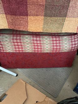 Slip covered red ottoman matches vintage red sofa and chaise.