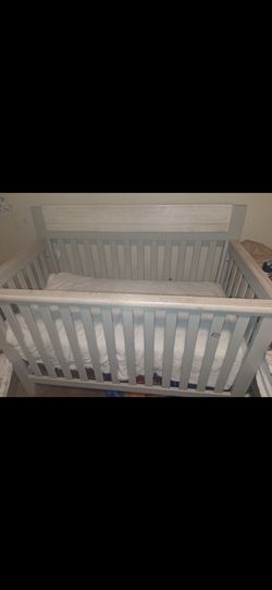 Wooden baby crib...includes new mattress and new cover