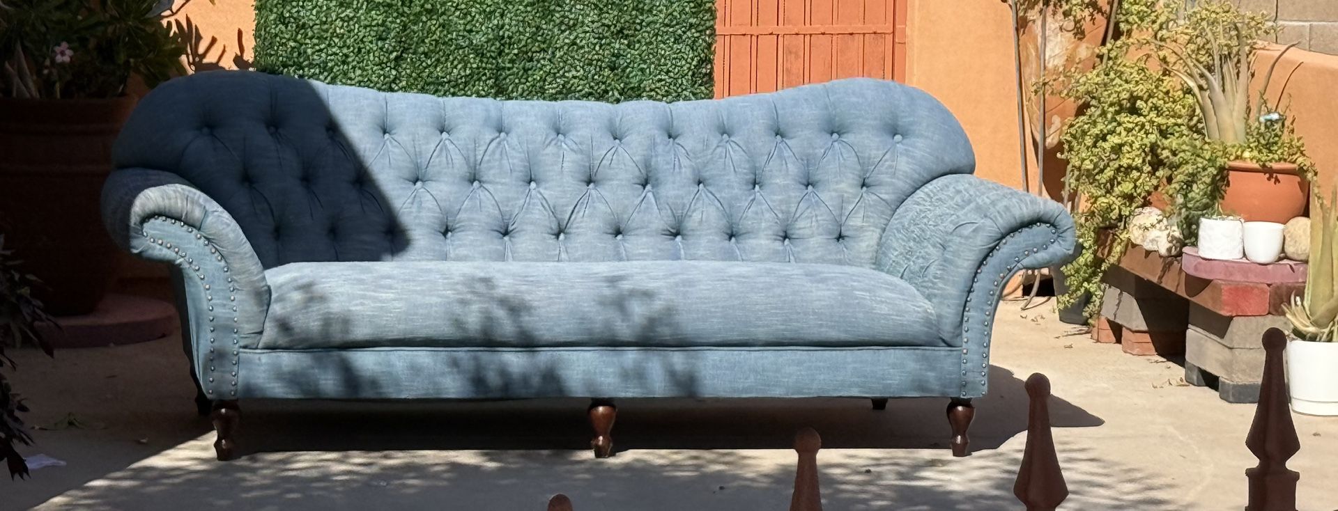 Tufted back designer looking teal sofa