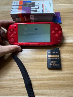 Red PSP 3000 with 100 games installed.          C67