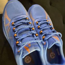 New Men Blue athletic shoes with orange accents, size 12. $30 Located Mount Dora Fla 32757