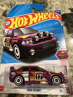 The product is a 2025 Ford Escort toy car in purple color, part of the Hot Wheels Art Cars series. This 1:64 scale diecast vehicle is unopened in its 