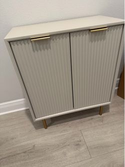 Grayish cabinets with gold hardware