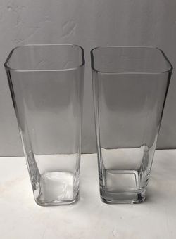 Tall square clear glass vase tapered at the bottom, 12 inches tall, 5 inches mouth, 3.5 inches bottom.  2 pieces available for $8 a piece.  