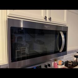 Whirlpool over range microwave with vent and light.