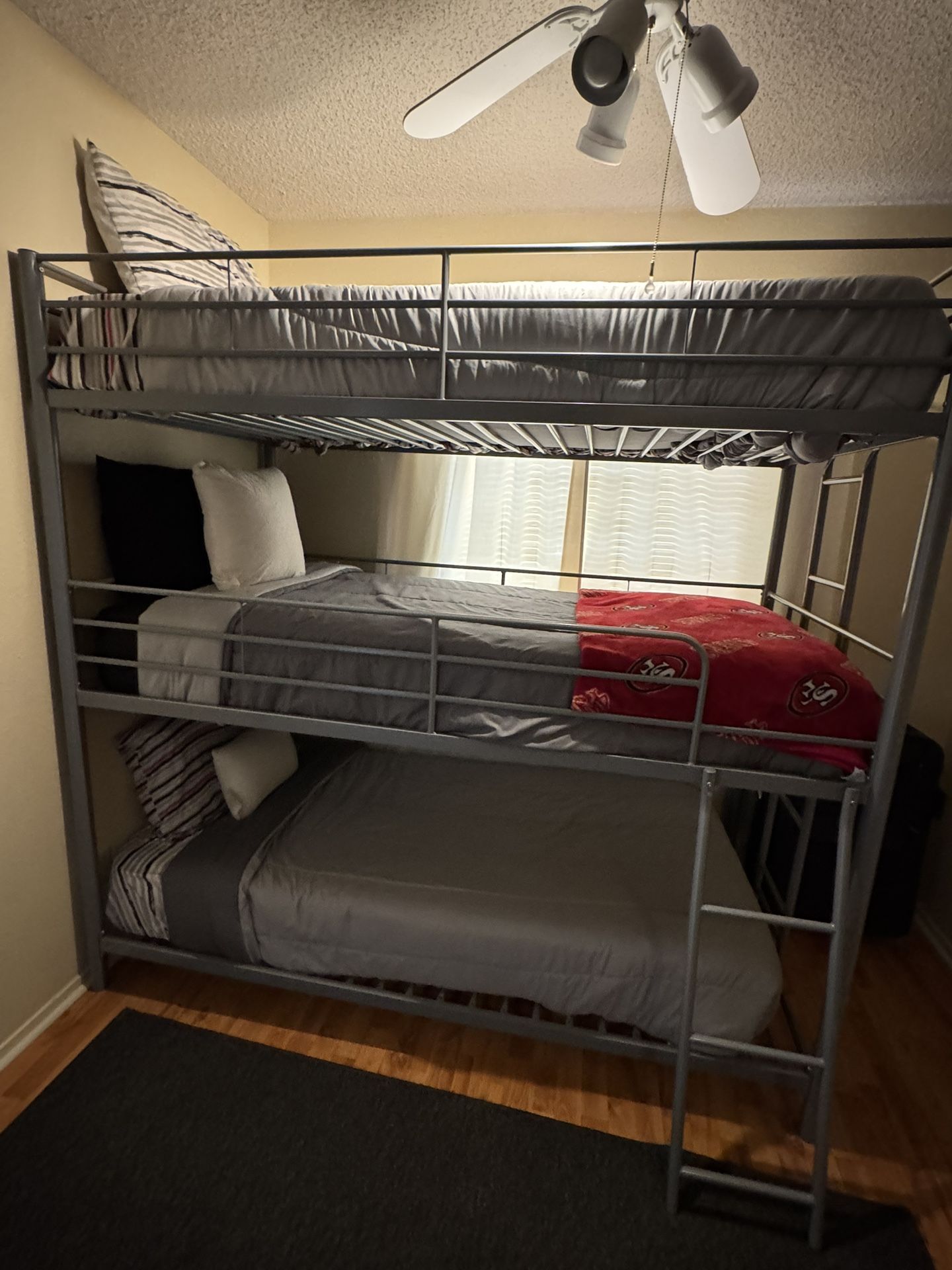 Triple stacked twin size bunk bed.