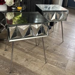 Modern mirrored side table with geometric design.