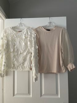 Off-white/Ivory color top with appliqués and a different top or tan blouse