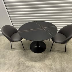 Modern black round dining table with 2 gray chairs