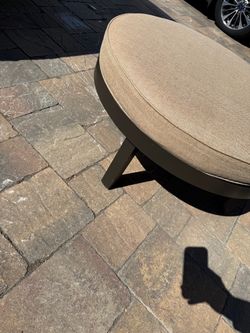 Round Upholstered Ottoman with Dark Base