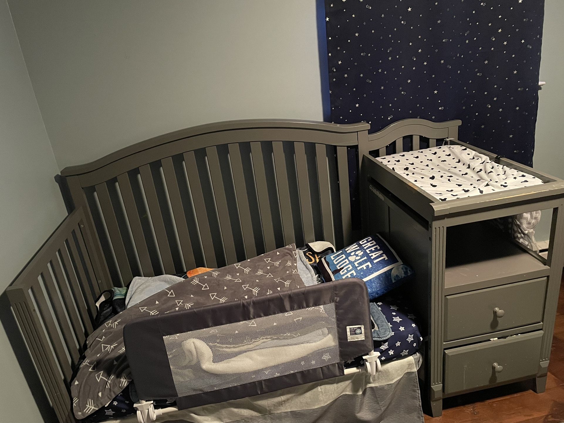 All-in-one crib with changer and storage drawers.