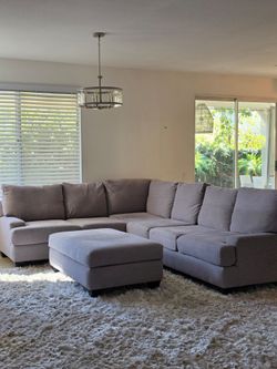 Large Gray L-Shaped Sectional Sofa with Ottoman – Living Spaces