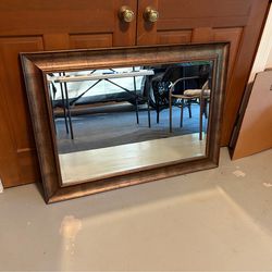 Wall mirror. Gold/bronze in color  43 1/4 long by 31 1/4 high