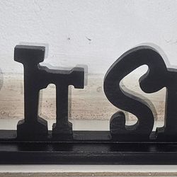 Tabletop wooden plaque or cut-out sign featuring the phrase "Keep It Simple". 20"L 4"W