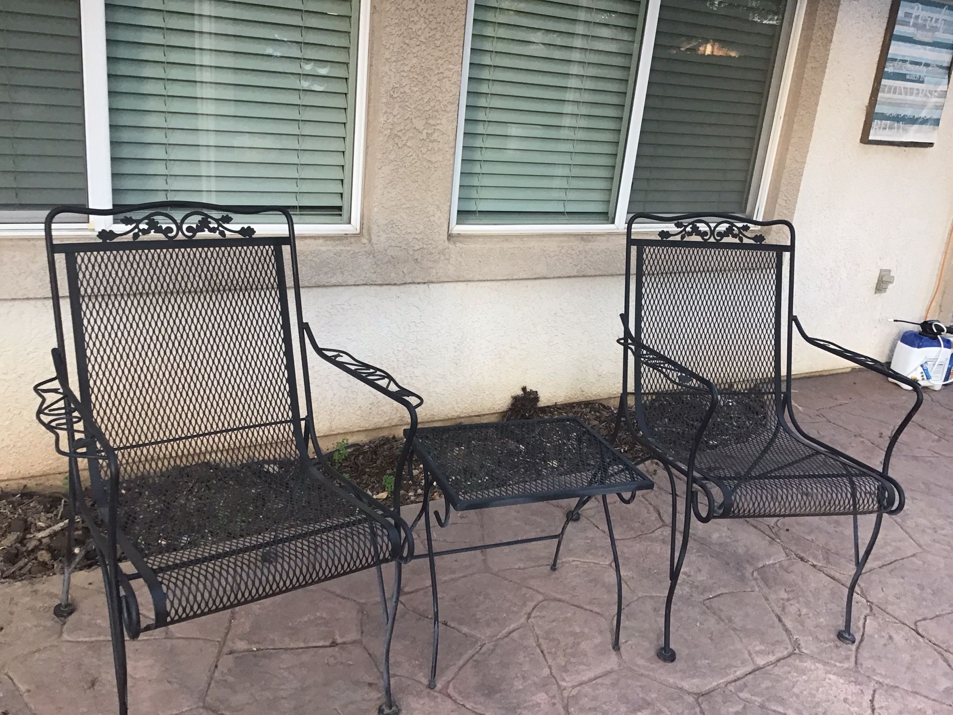 Two Wrought Iron Chairs And Small Table